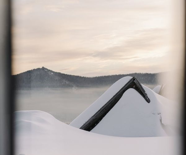 Person meditating outdoors with a serene landscape.